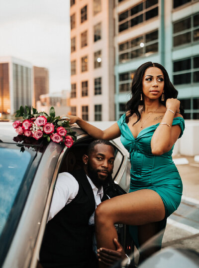 couple posing in car with flowers