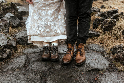 Closeup photo of dirty shoes of a married couple who eloped in Iceland