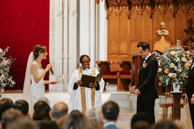 Bride reading vows at church ceremony, Unique Melody Events & Design helped with wedding