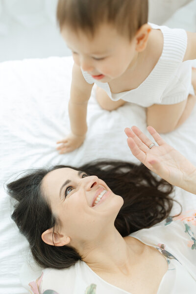 Mother looks up at her baby