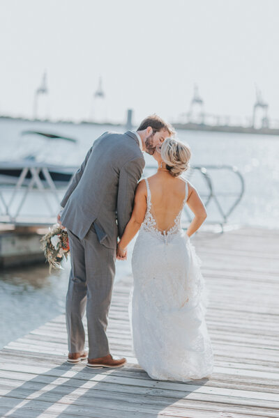 Newlywed Couple Kissing on Dock at Norfolk Yacht Club for Summer Waterfront Outdoor Wedding