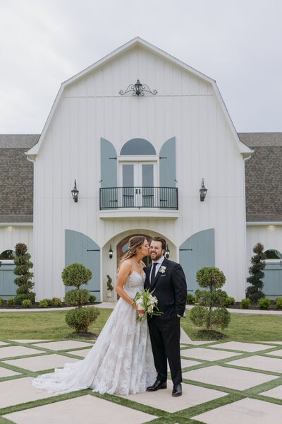 Bride and groom stand outside of The French Farmhouse Wedding Venue