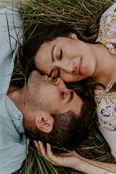 man and woman laying on ground