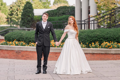 A newly married couple embracing at the Prestonwood Country Club in Cary during the fall sunset by Raleigh wedding photographer, JoLynn Photography