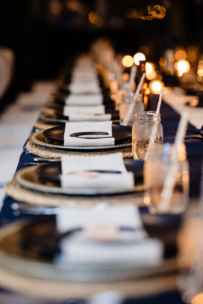 View looking down a table that is set with plates and napkins.