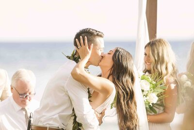 newlywed couple kissing after ceremony