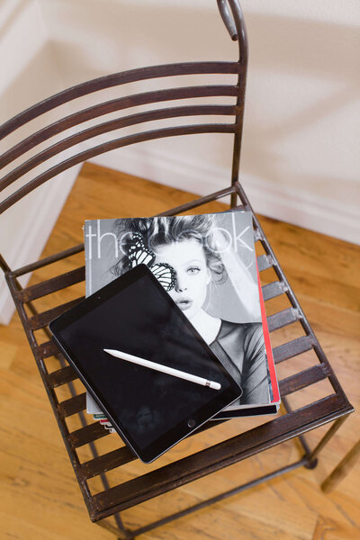 magazine and planner on black chair
