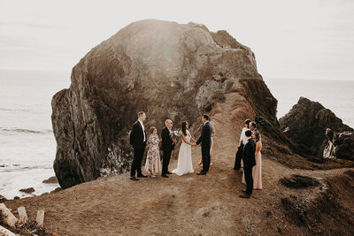 far view of an elopement ceremony on a cliff side