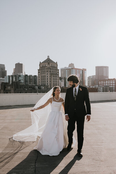 a bride and groom standing on a church balcony overlooking the sanctuary