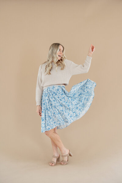 woman curtsies floral skirt