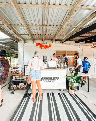 Quigley Coffee Co mobile cart serving customers at an outdoor market, providing specialty coffee catering for festivals and community events.