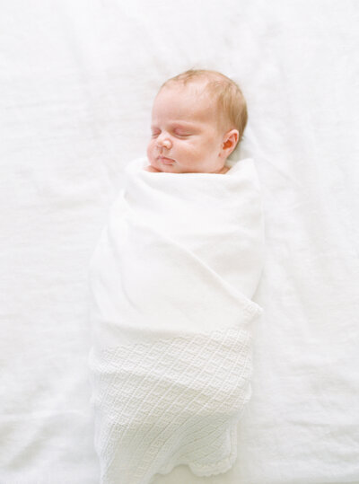 Newborn Baby Swaddled in a white blanket