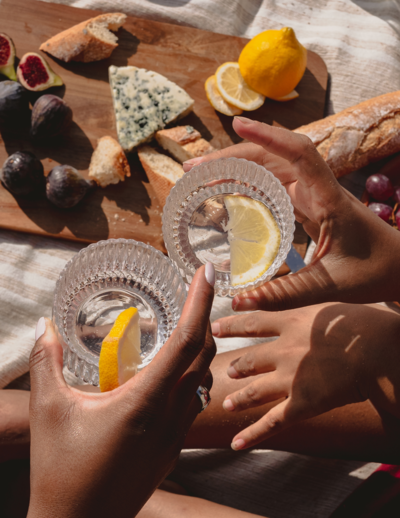 Black people holding cocktails and cheersing