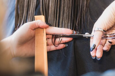hands-cutting-long-brown-hair