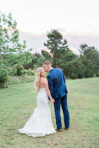 Bride in Lace Dress with Groom in Navy Blue Suit at Wingate Plantation Wedding