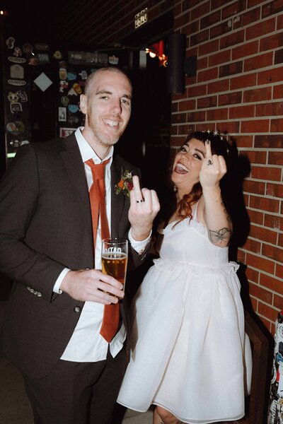 couples giving the middle finger colorado elopement