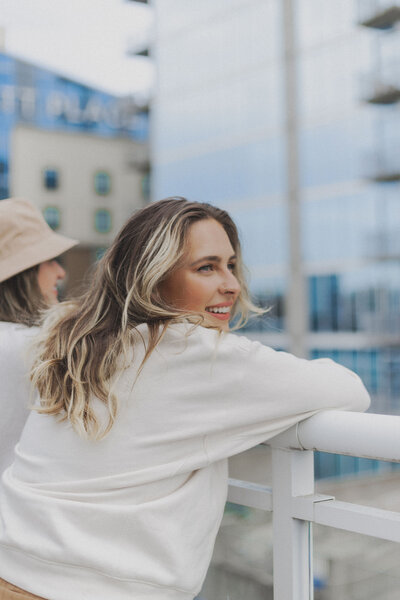 A woman holding a drink while reading a book. Showing that with anxiety therapy in Manhattan you can calm the inner chaos. An anxiety therapist can help you learn to relax and enjoy every day.