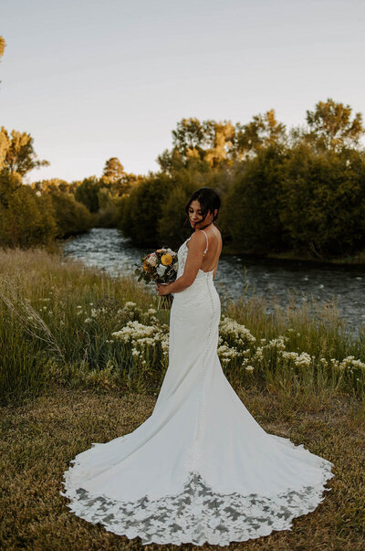 bride in front of river at Log River Ranch