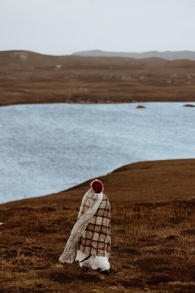 Bride in blanket in Scotland