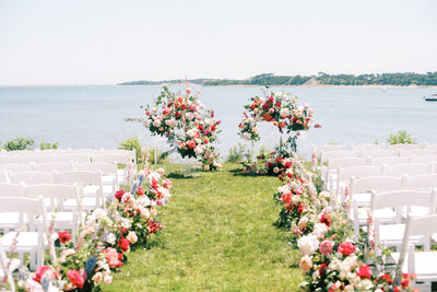 outdoor wedding ceremony featuring arches florals