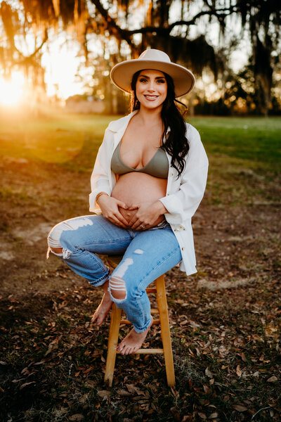 casual pregnancy pose with exposed belly and unbuttoned shirt in new Iberia, la