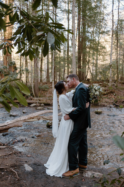 Bride and groom walking to their ceremony site at their Smoky Mountain elopement.