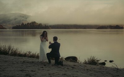 Romantic proposal by a serene Scottish lake, capturing the heartfelt moment of love and commitment in a stunning natural setting, filled with emotion and beauty