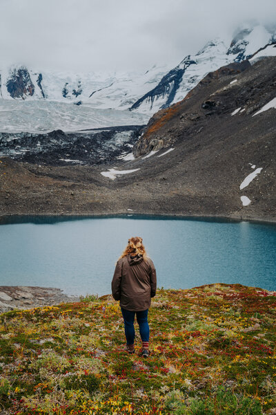 Woman looking at glacier lake in Alaska