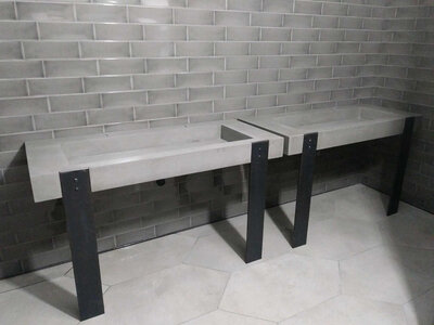 Custom concrete trough sink for commercial space with steel base