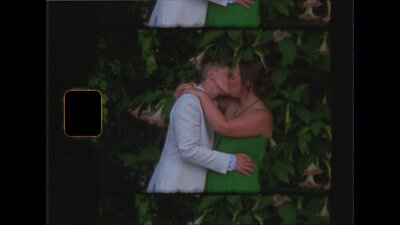 super 8 still film image of wedding couple kissing under flowering tree