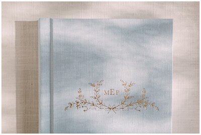 A light blue fine art photo album with gold embossing