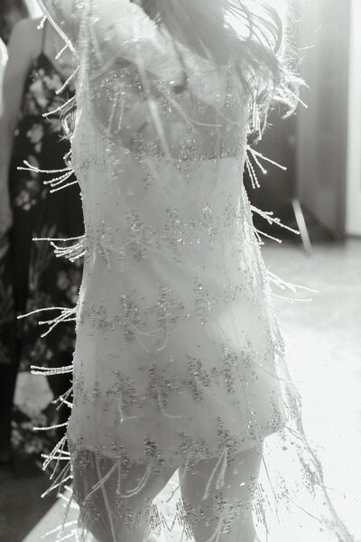Bride dancing at The Surf Hotel in Buena Vista, Colorado in a beaded after party dress.