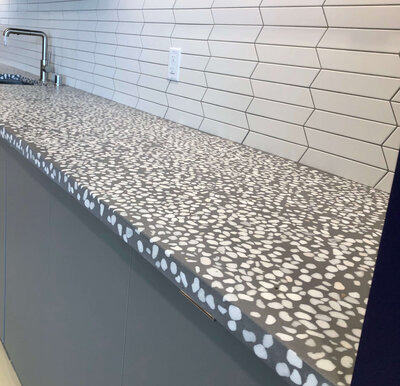 Close up of concrete with with exposed white aggregrate terrazze on corporate breakroom for Radisson Worldwide Headquarters