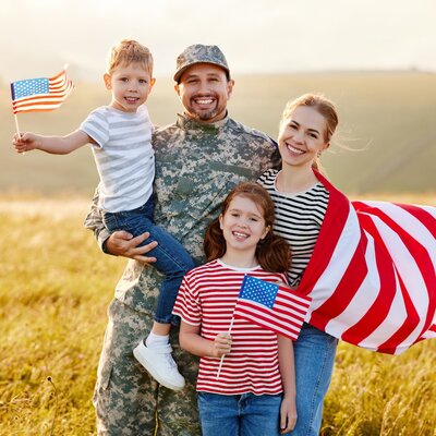 military family wearing and waving American flags discount for veterans at home inspection company in punta gorda florida