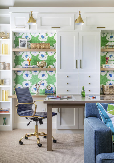 office with table and chair and green floral wall paper