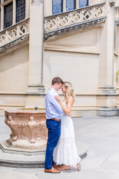 couple hugging in front of fountain at Biltmore Estate in Asheville, North Carolina