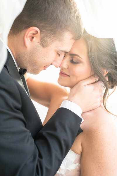 Bride and groom embrace forehead to forehead