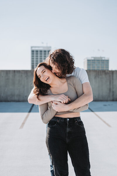 man hugging woman from behind