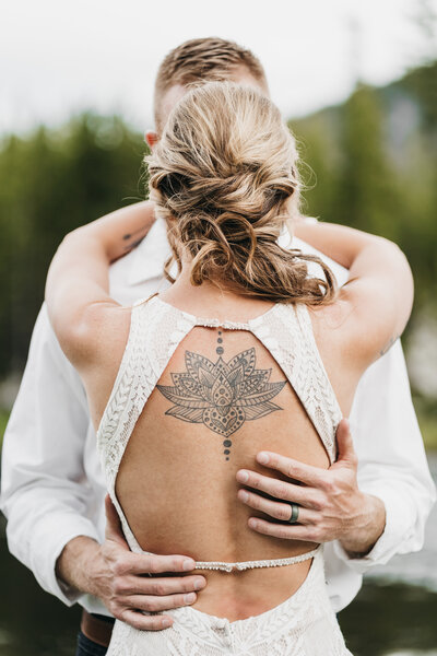 Detail shot of the brides dress and tattoos.