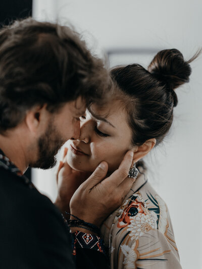 man kissing woman on a cheek