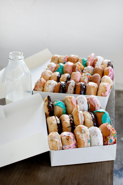 Two Boxes Full of Donuts on a Table - Daylight Donuts
