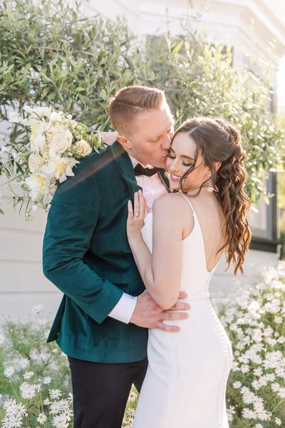 Groom kissing bride