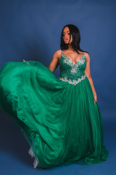 African American Woman in Green Prom Dress with Blue Background
