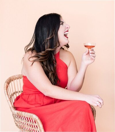 happy woman in a red dress with pink cocktail