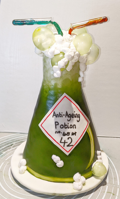 Conical flask with edible bubbles, chemistry themed cake