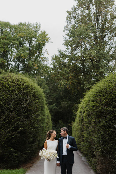 couple holding hands on road