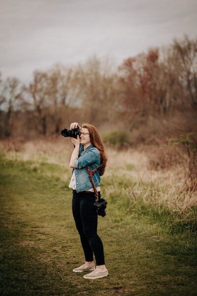 photo of woman taking a picture with her camera