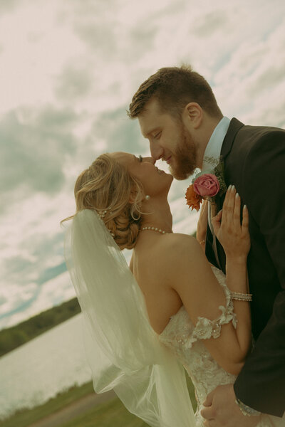 A couple holds hands while walking down the sidewalk, laughing and having fun