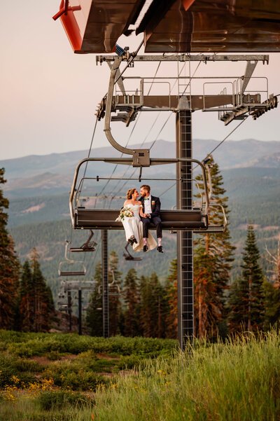 A bride and groom riding the ski lift at Northstar California