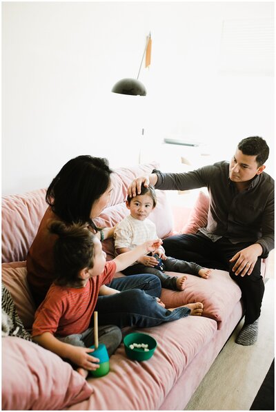 Family with two young kids sitting on couch at Austin family photoshoot